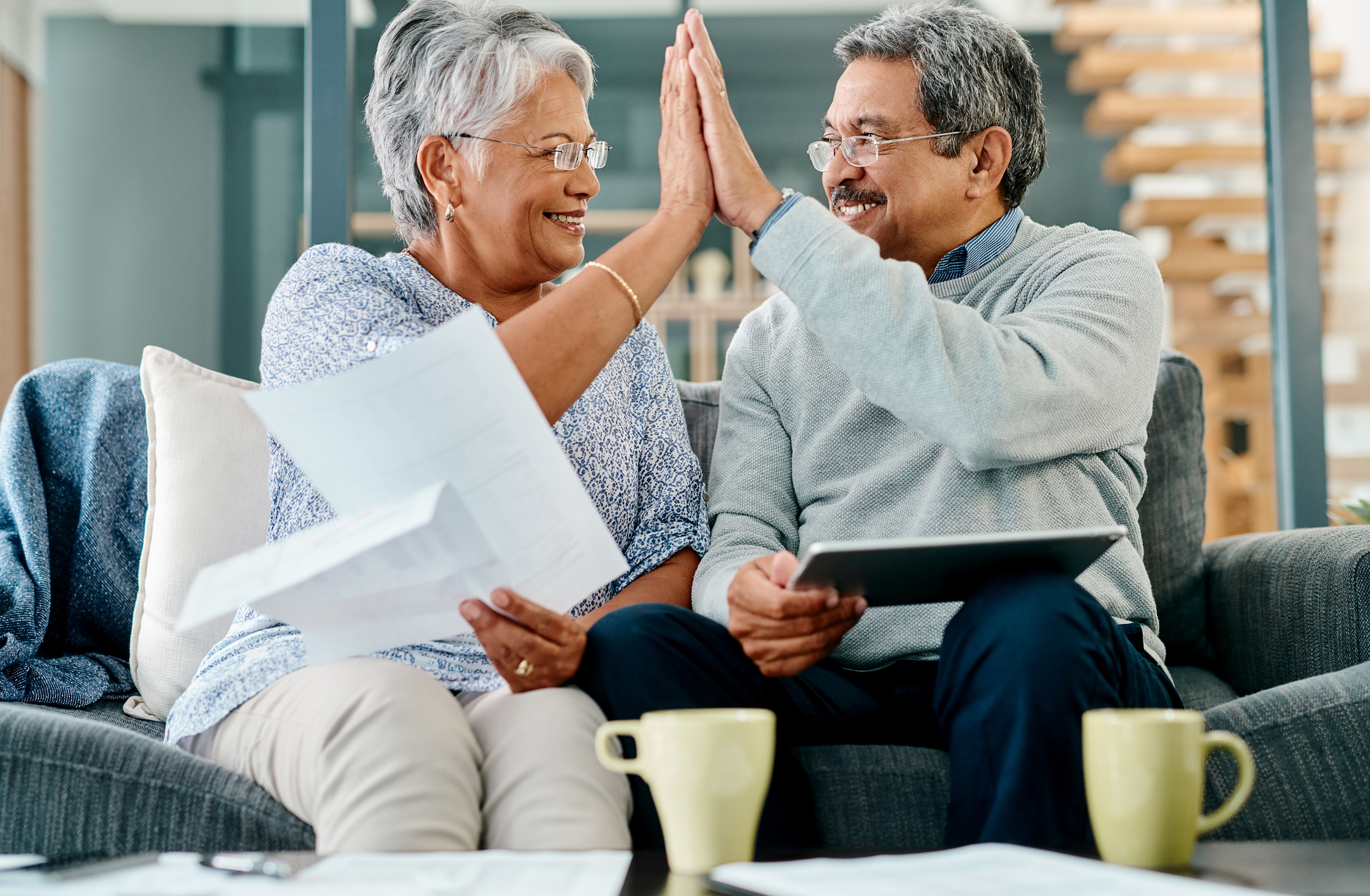 Gold IRA Investing Company getty couple high five happy